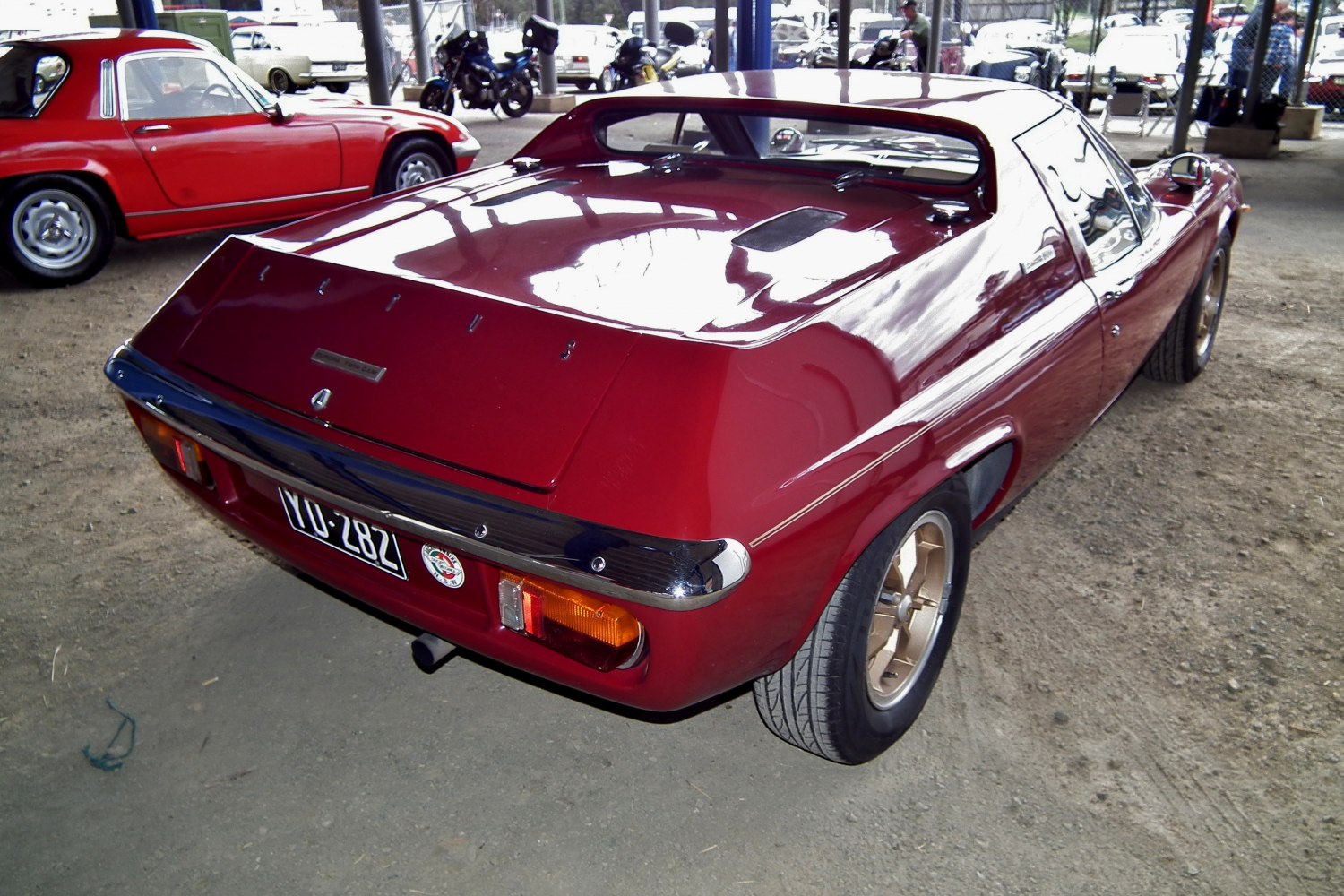 Retro sports coupe rear with spoiler and gold alloy wheels