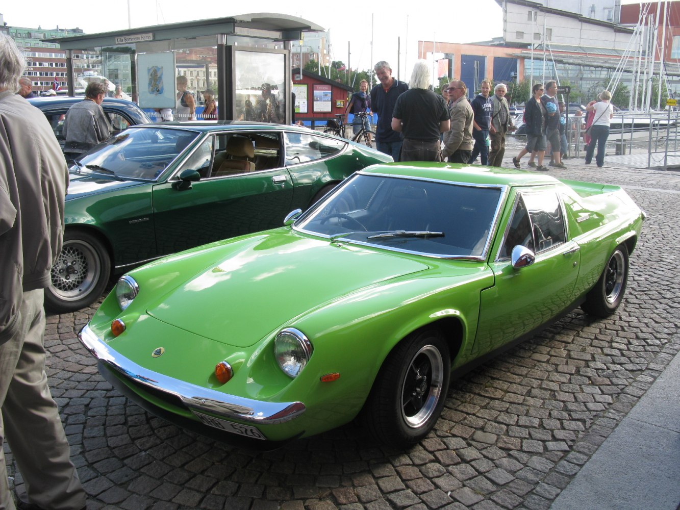 Bright green vintage rear-engine sports coupe with pop-up headlights