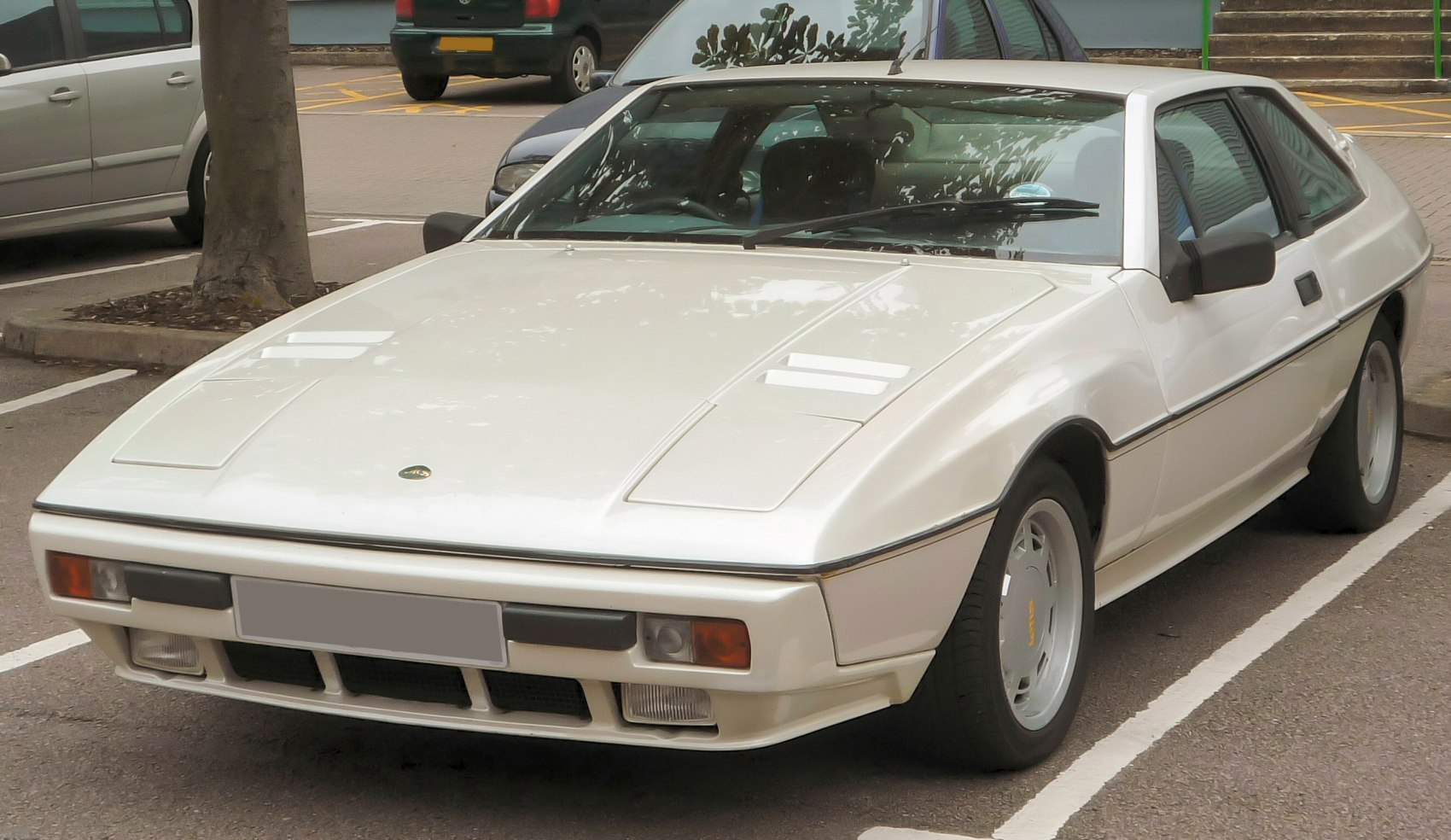 White classic wedge-shaped sports coupe with pop-up headlights