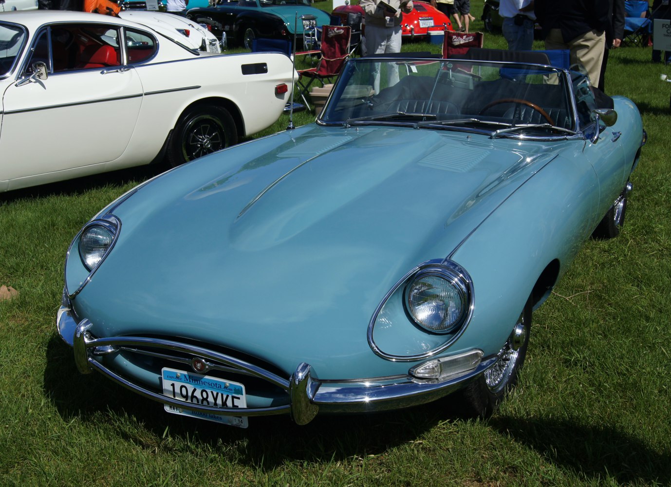 Sleek front with rounded headlights and chrome bumper on classic convertible
