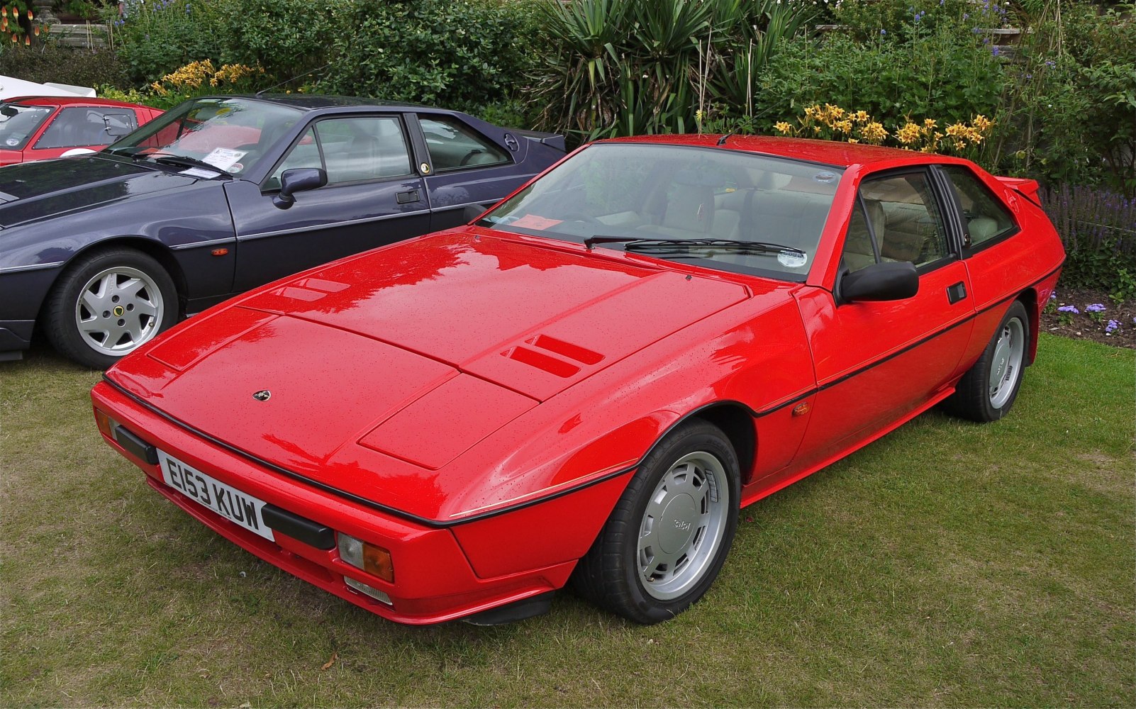 Red sports coupe with pop-up headlights and wedge shape