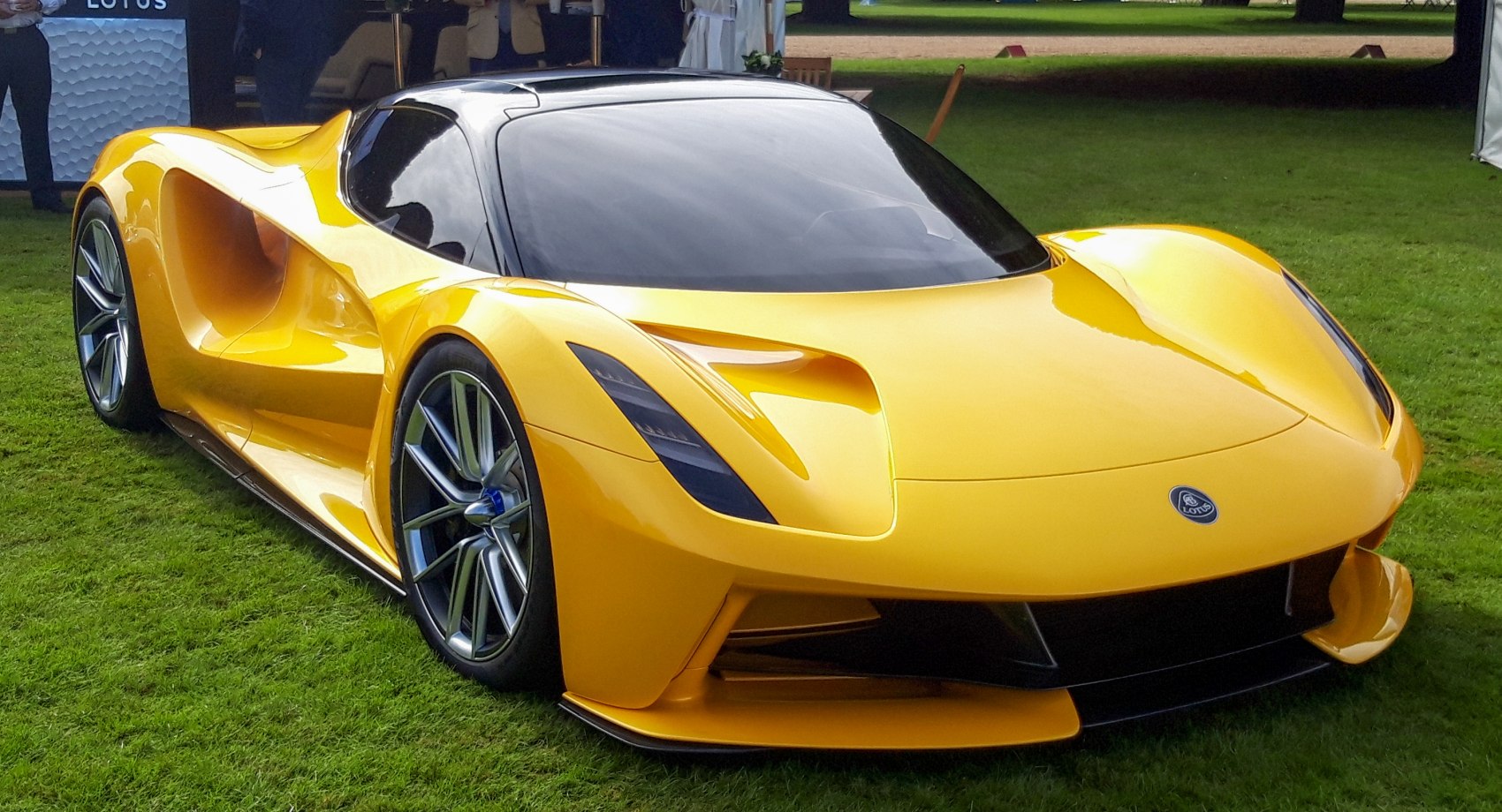 Aerodynamic yellow electric hypercar with sleek design and sporty wheels