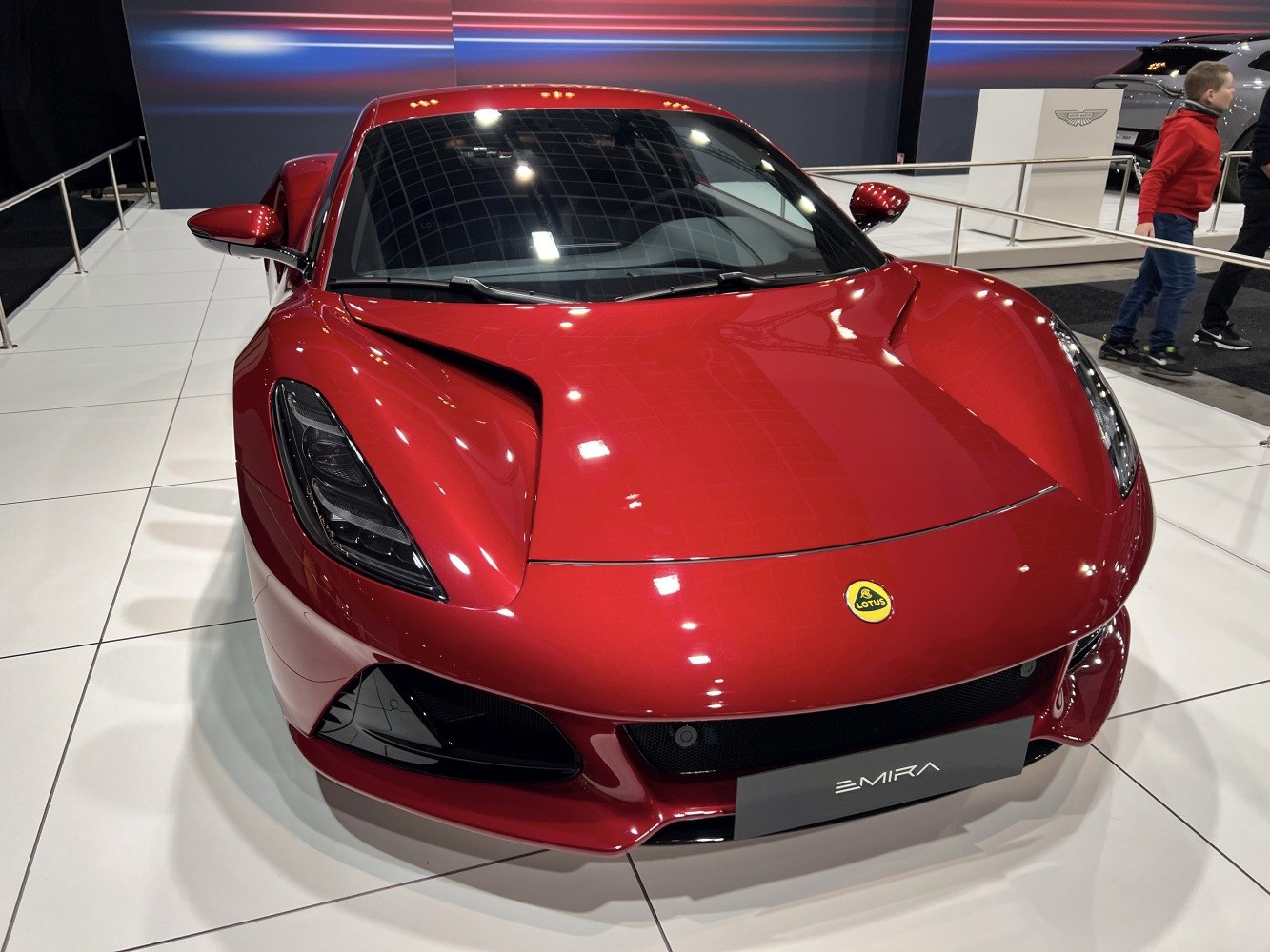 Sleek red sports car front with aerodynamic headlights.