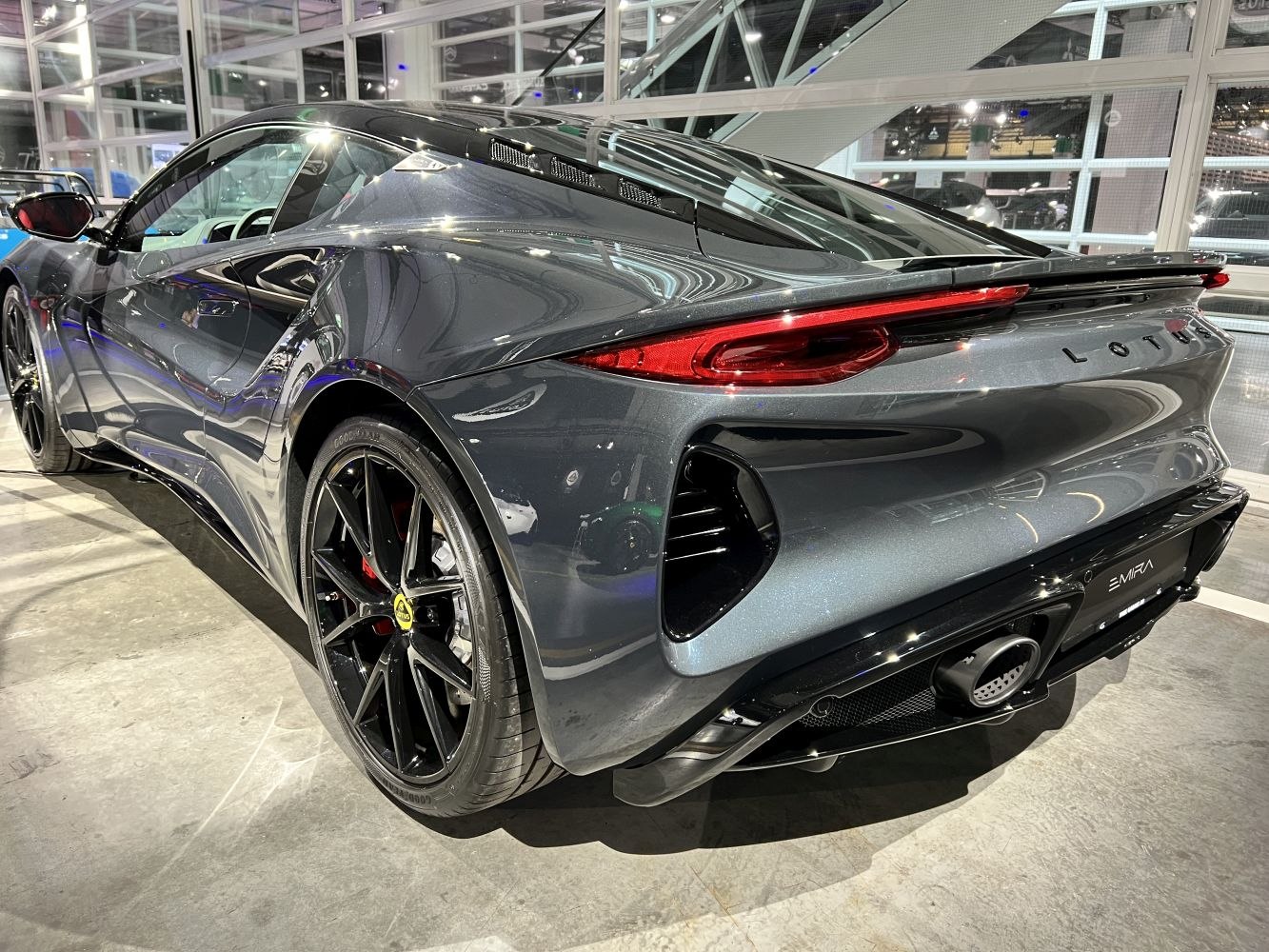 Sleek rear and side view with aerodynamic curves and black alloy wheels