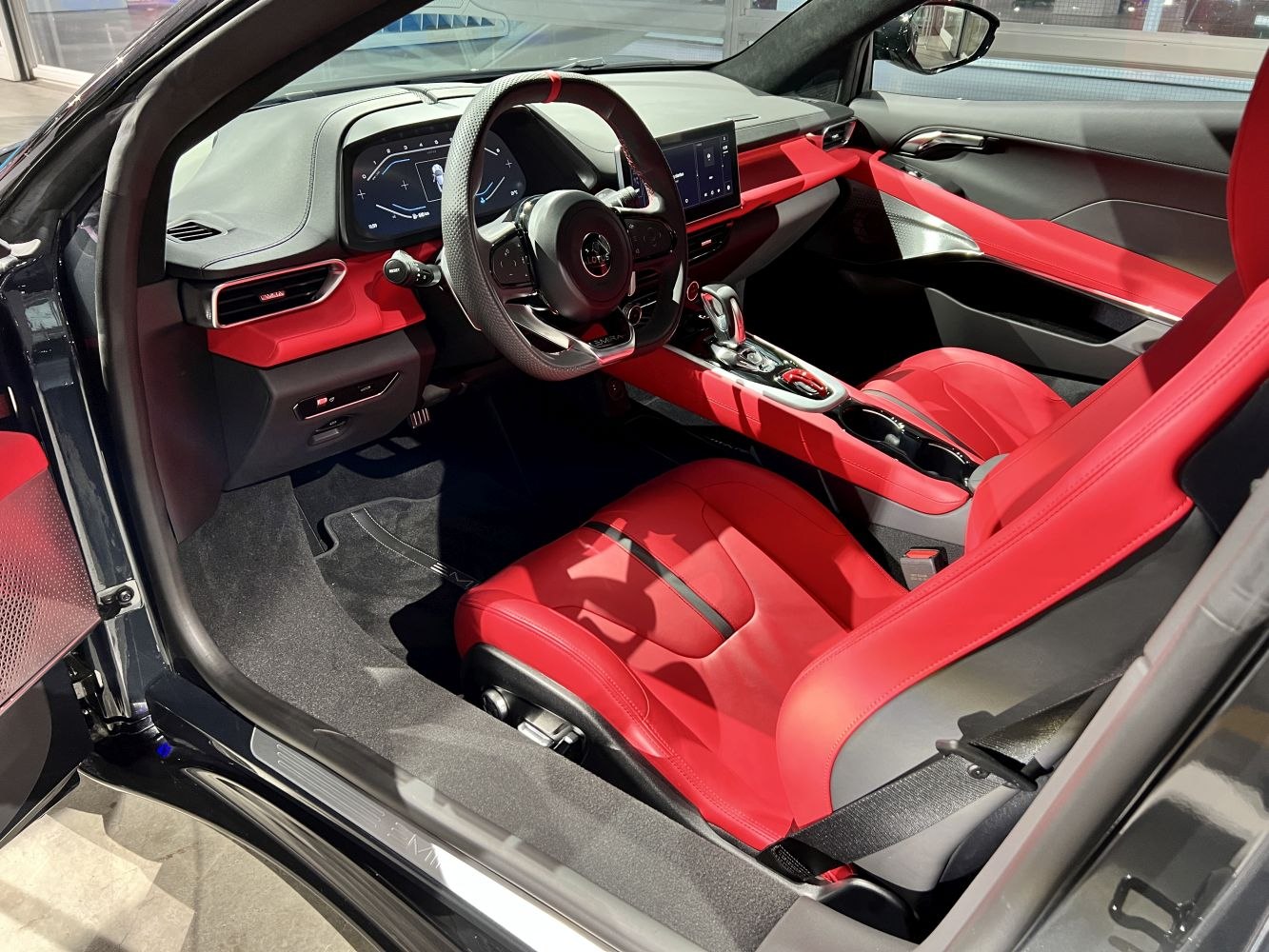 Red leather sport seats with digital dashboard and modern center console