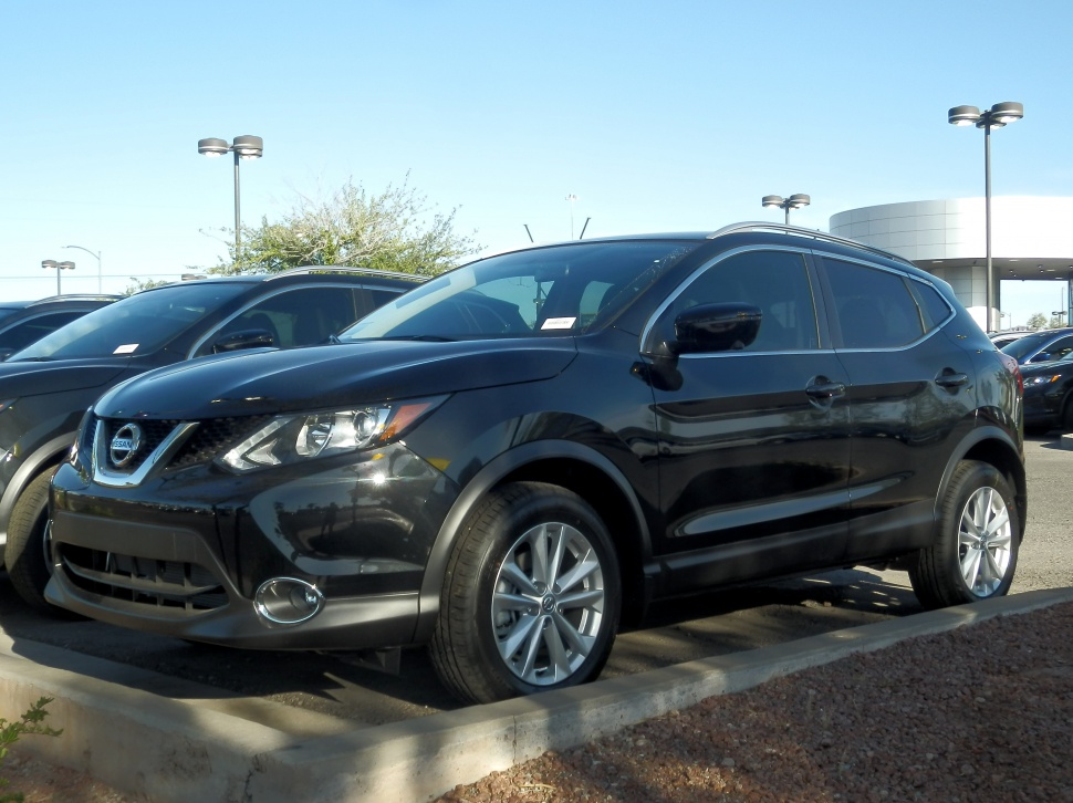 Front side view of black compact SUV with alloy wheels and modern headlamps