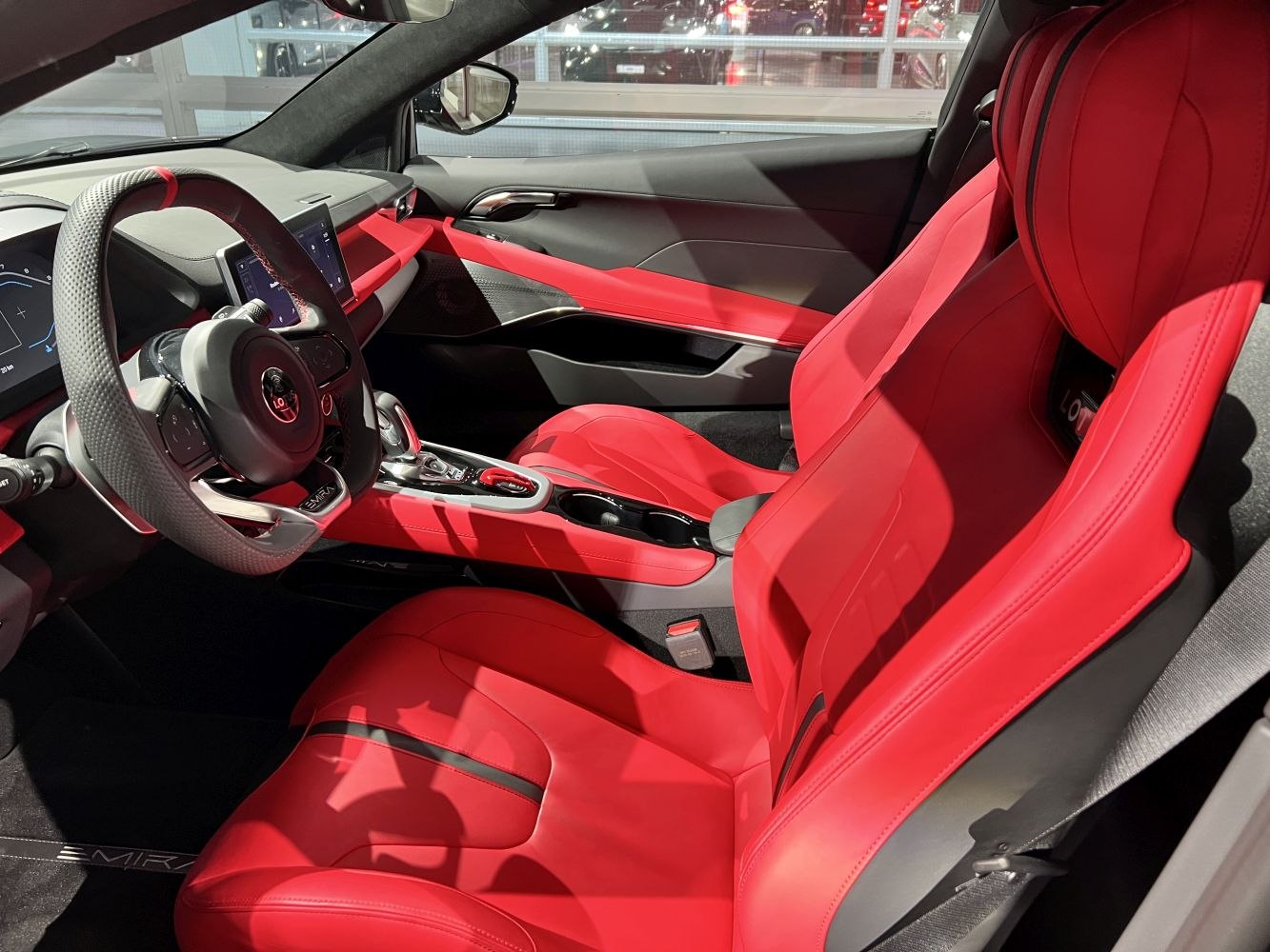 Red leather seats and digital dashboard in modern car interior