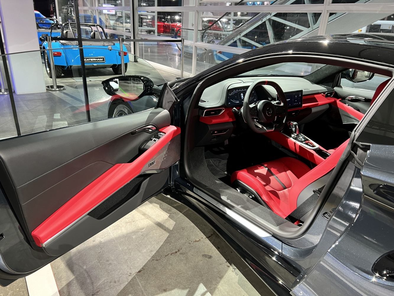 Sporty red and black driver-centric interior with digital displays