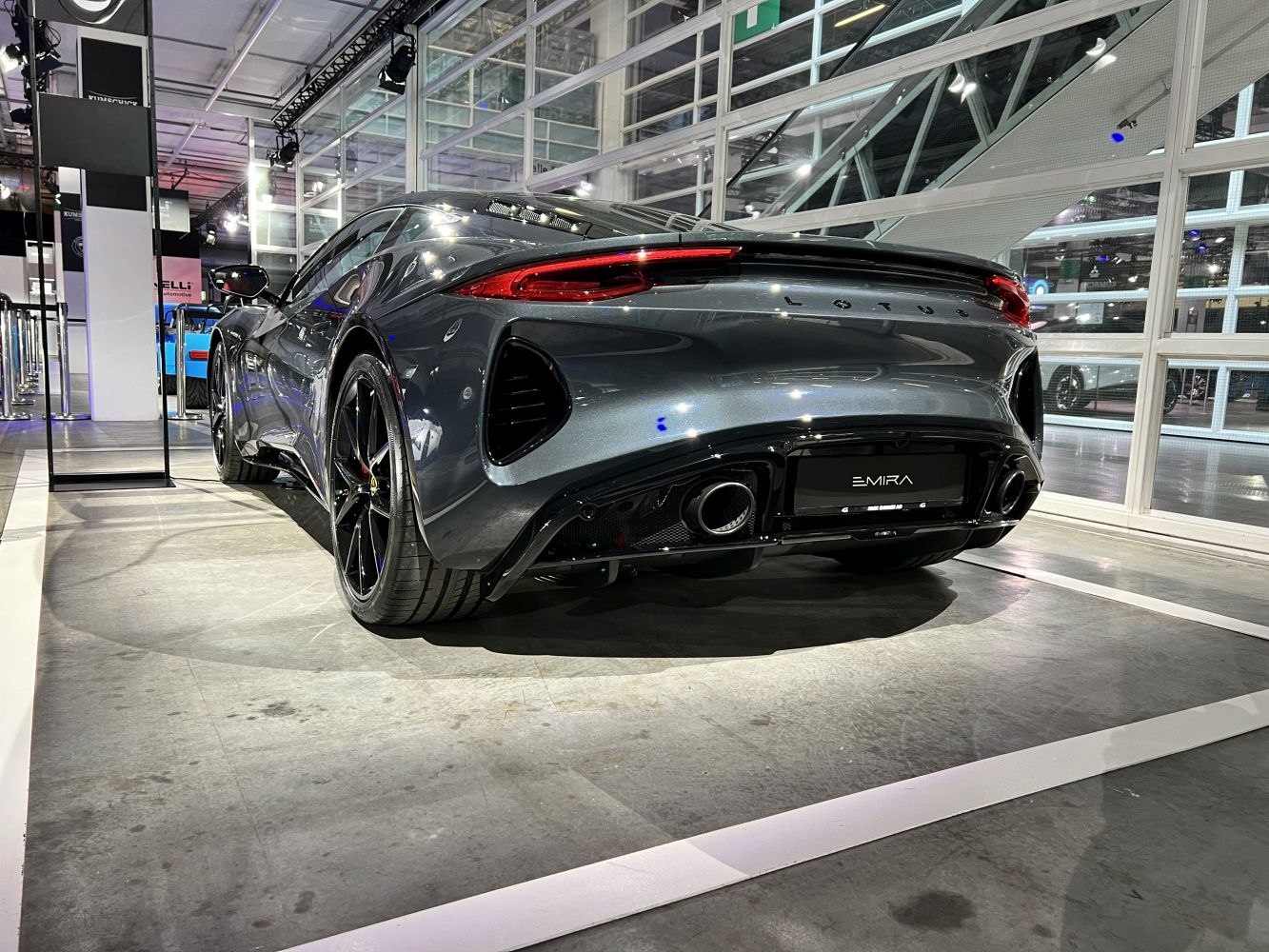 Rear view of a sleek sports car with dual exhausts and aerodynamic curves.