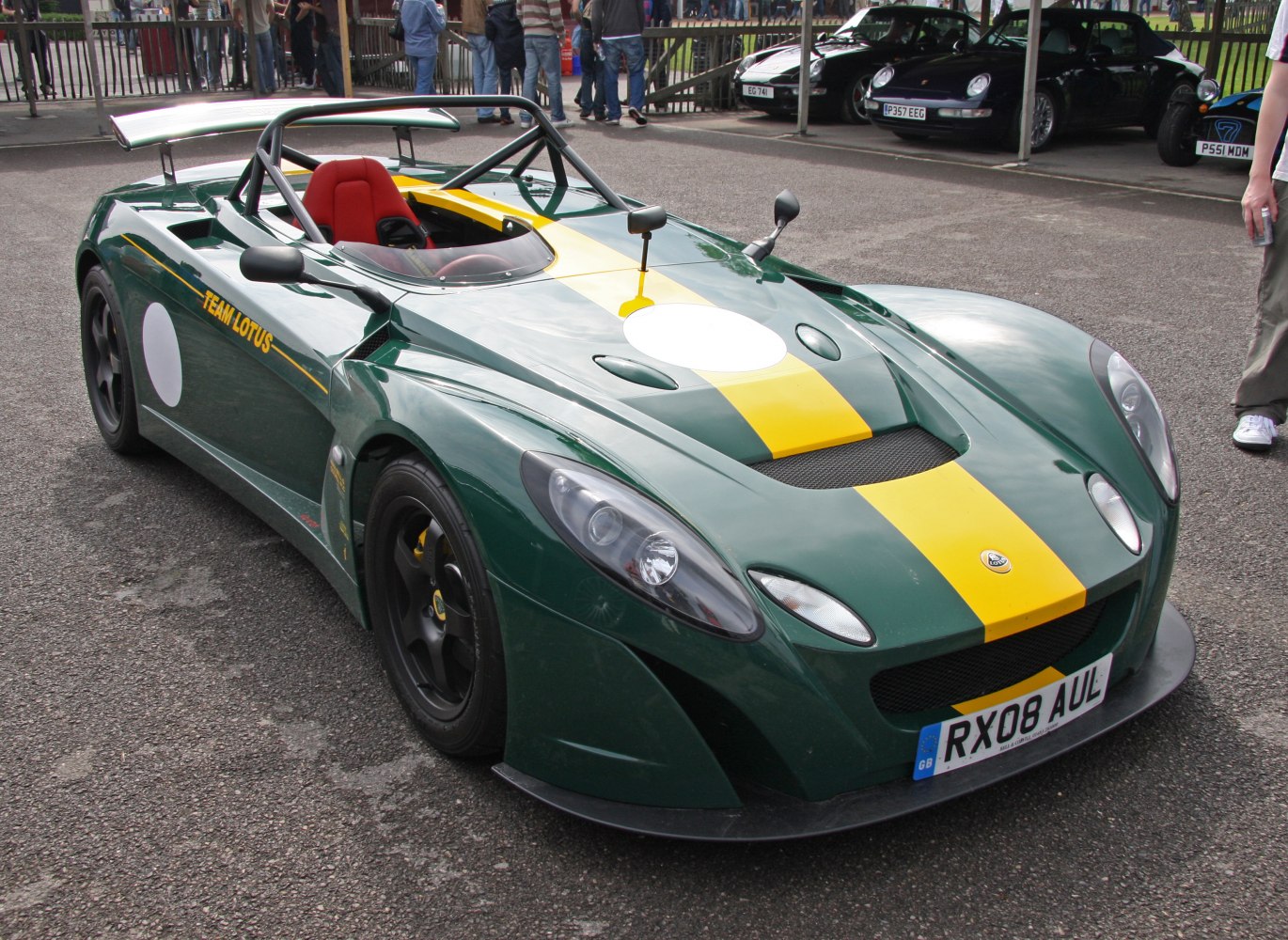 Open cockpit sports car with large rear wing and racing livery