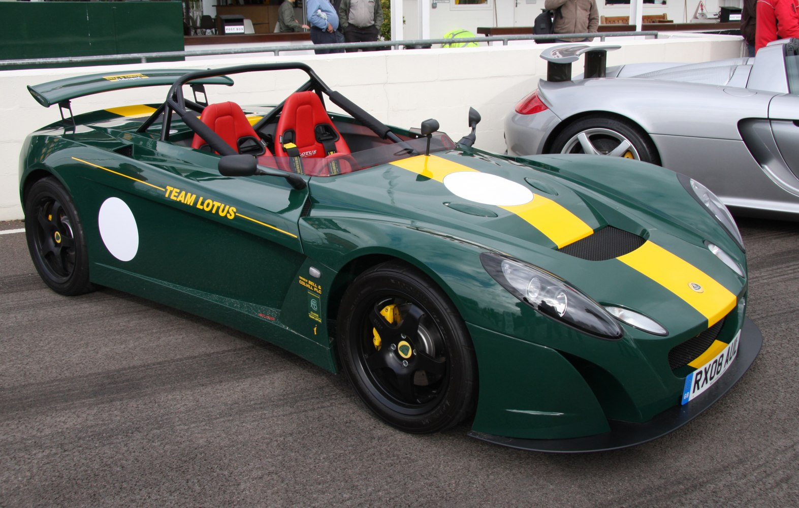 Open cockpit sports car with red racing seats and yellow-green racing livery
