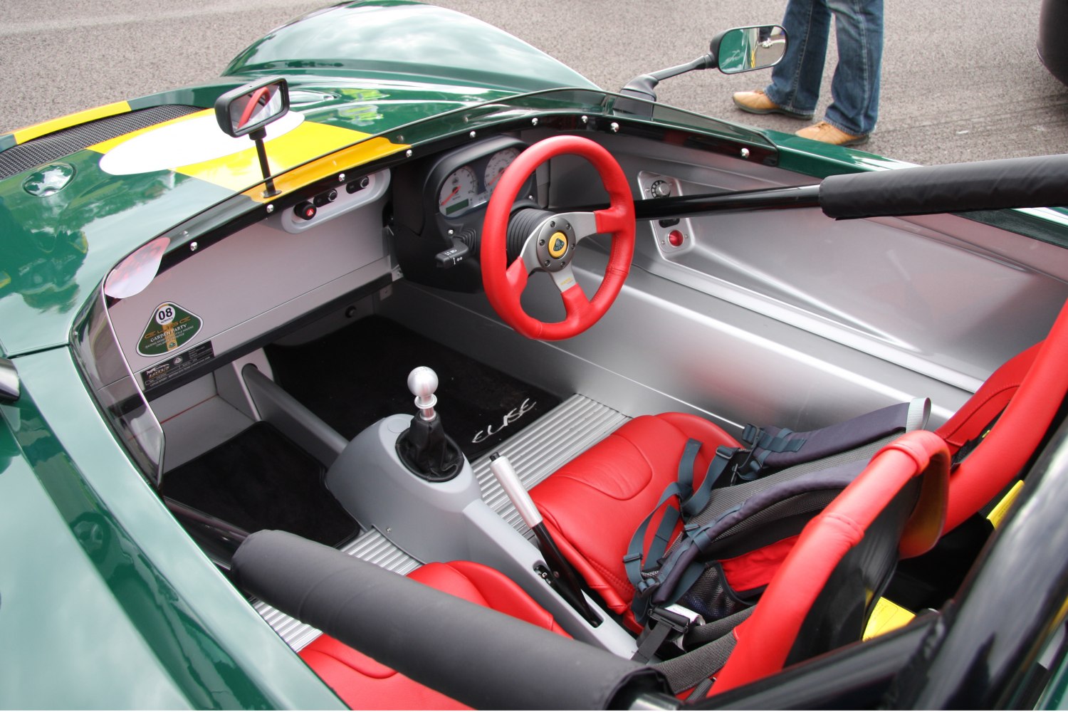 Racing-style red seats and manual gear shifter in minimalist sports car interior