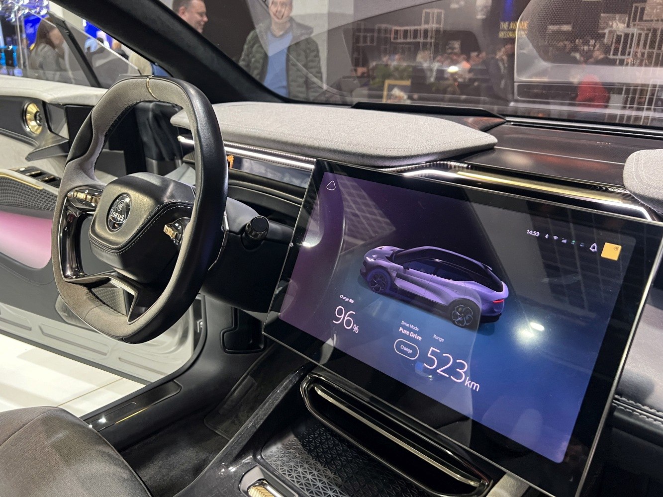 Digital infotainment screen and distinctive steering wheel in car interior