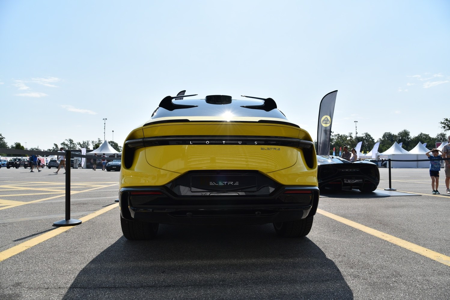 Rear view of a sleek, futuristic electric SUV with continuous tail light and aerodynamic design