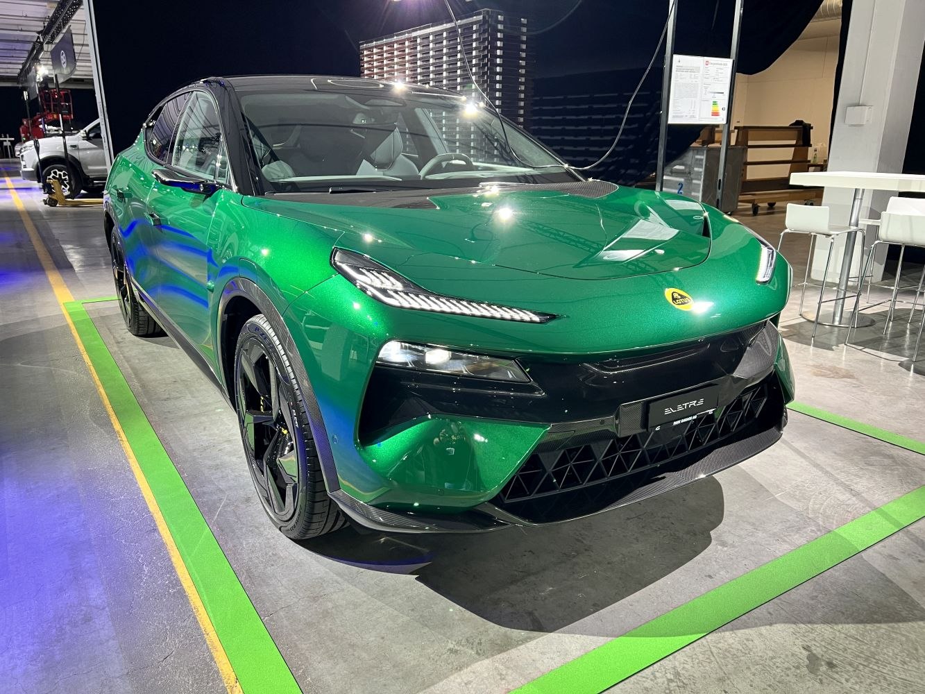 Front view of a sleek green electric SUV with LED headlights and aerodynamic design.