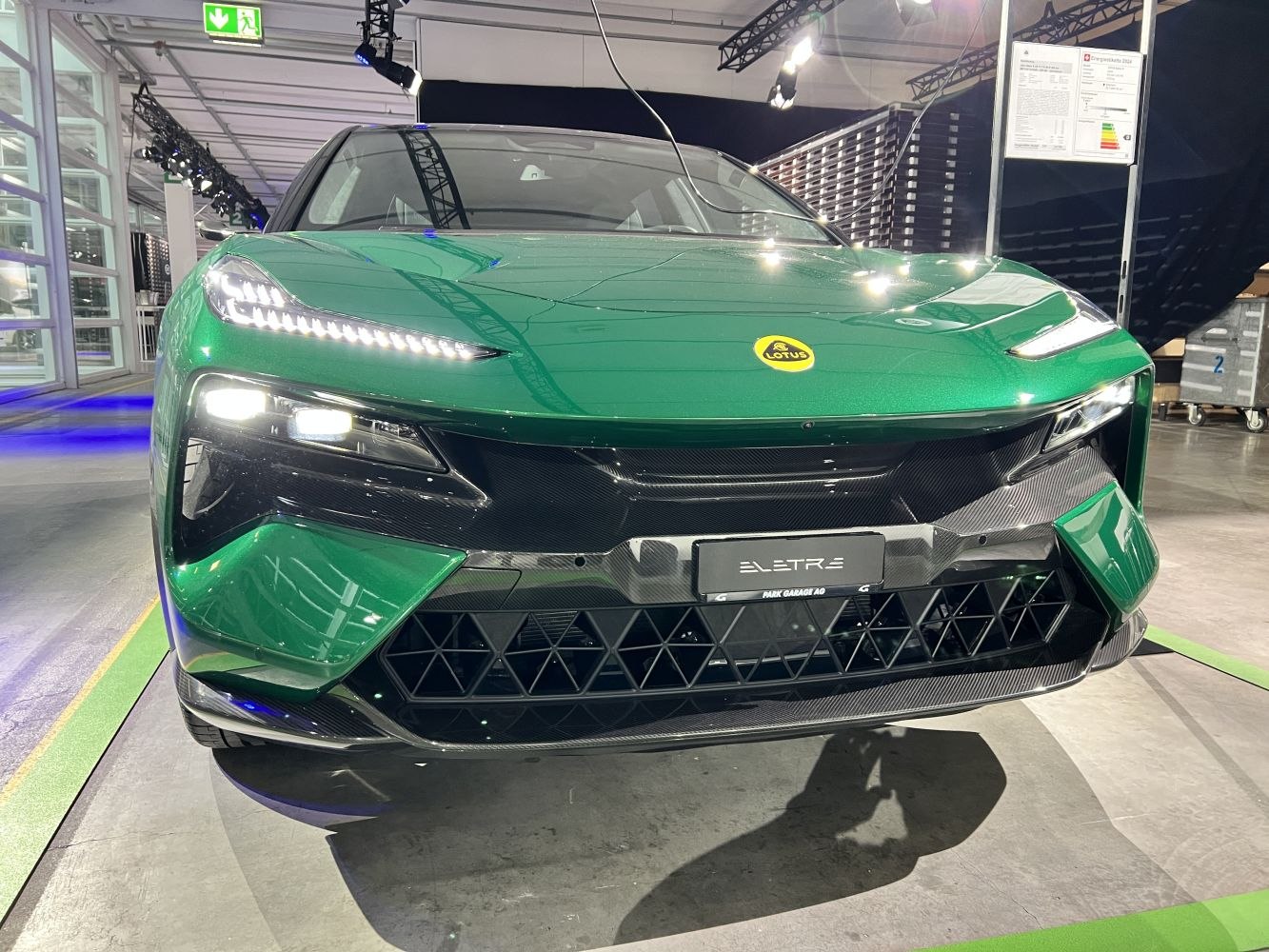 Close-up of LED headlights and aerodynamic front grille in green finish