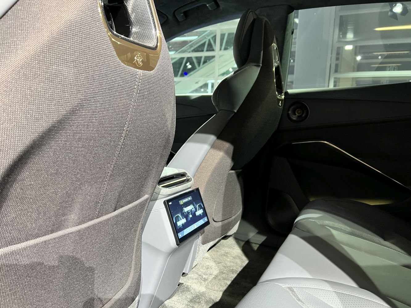 Rear-seat touchscreen control panel and modern upholstered seats