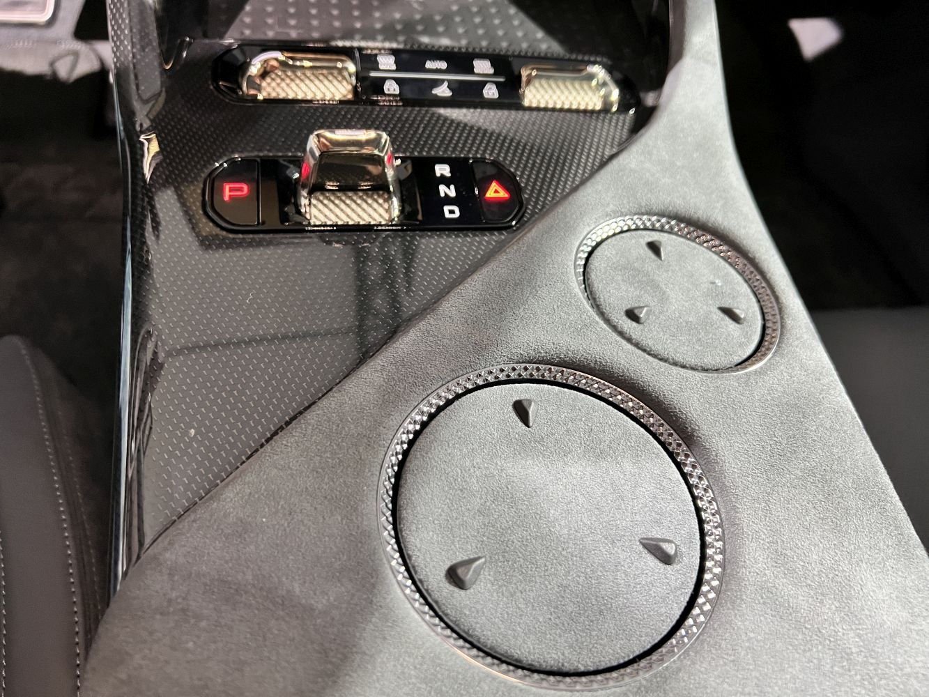 Gear selector buttons and textured control knobs on luxe center console