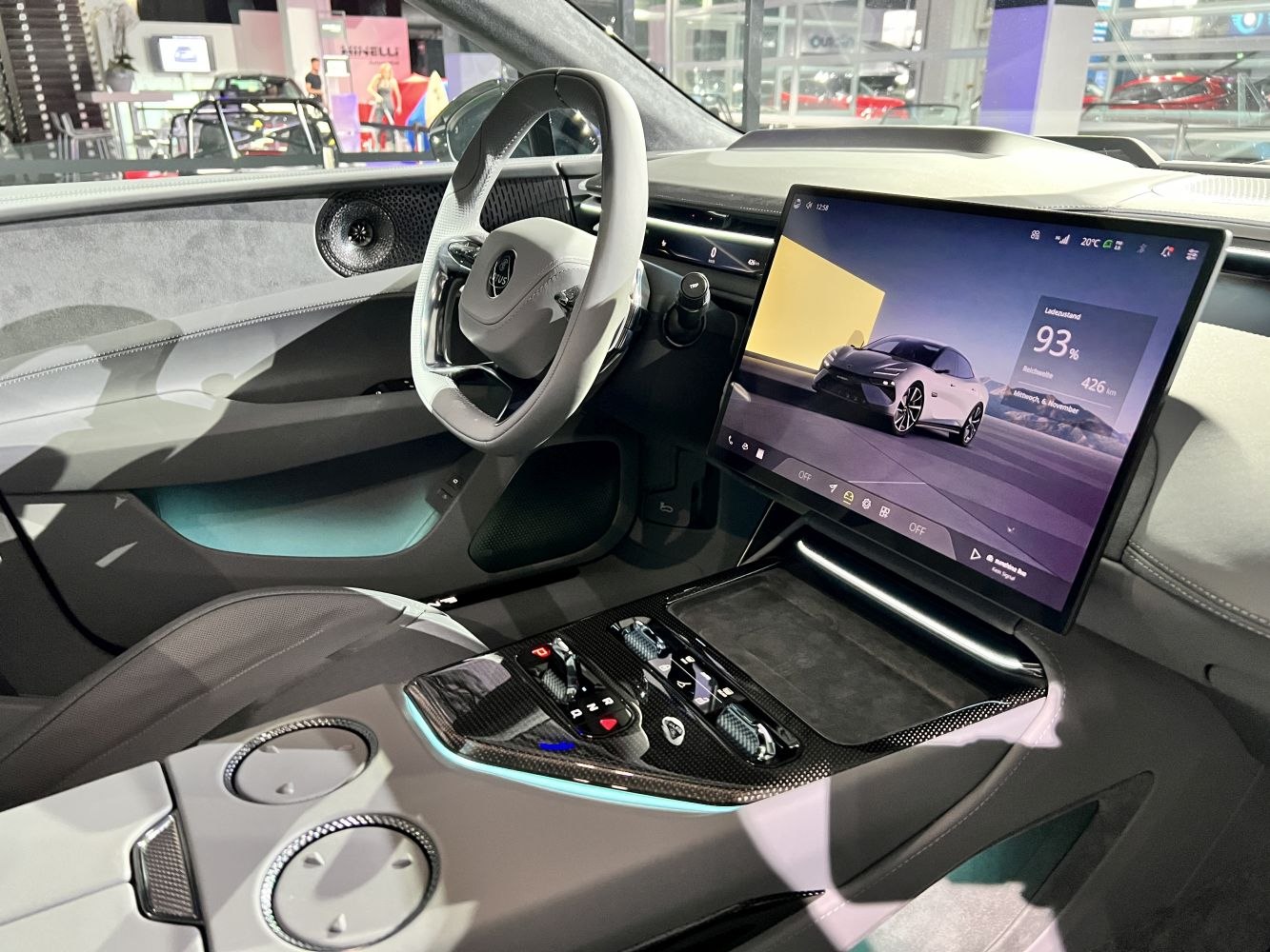 Digital touchscreen display and futuristic steering wheel inside car interior