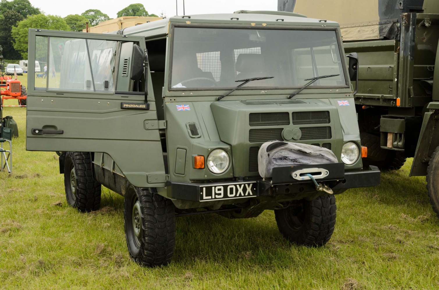 Military-style off-road vehicle with winch and rugged design