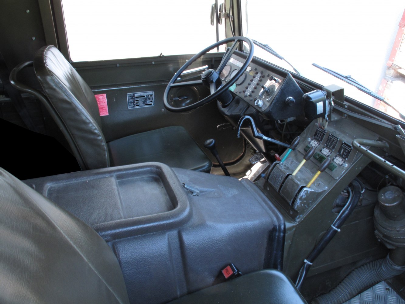 Military vehicle interior with dashboard and control levers