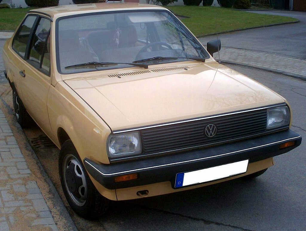 Front view of vintage sedan with rectangular headlights and classic grille