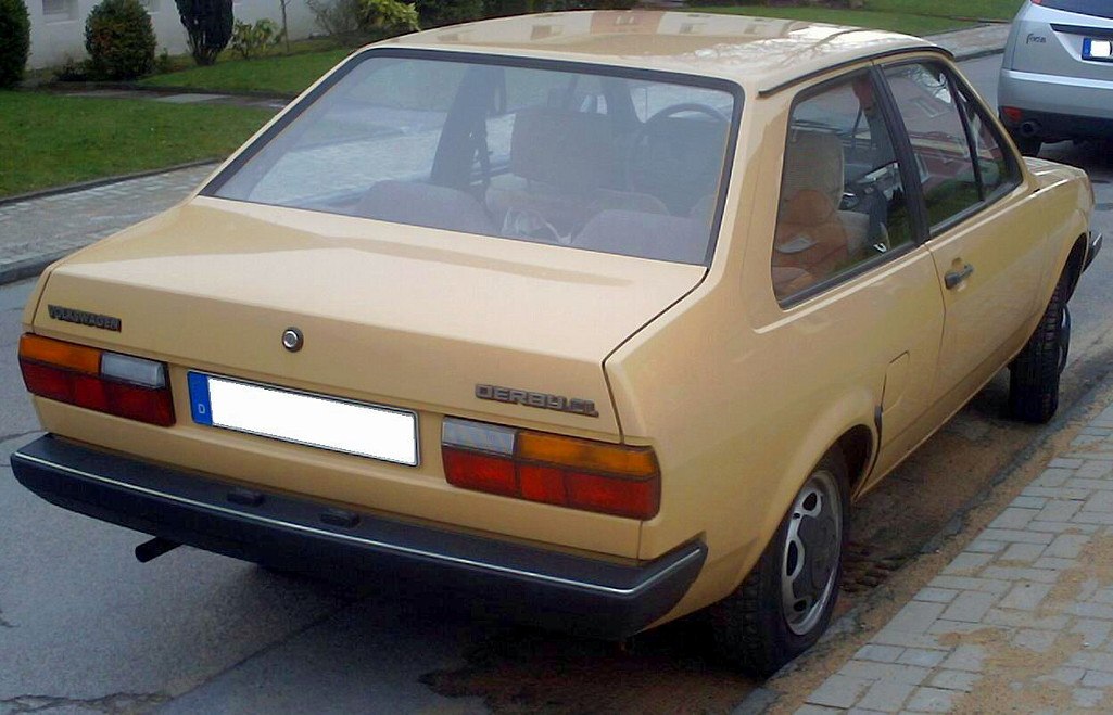 Beige vintage sedan rear with angular design and distinct taillights.