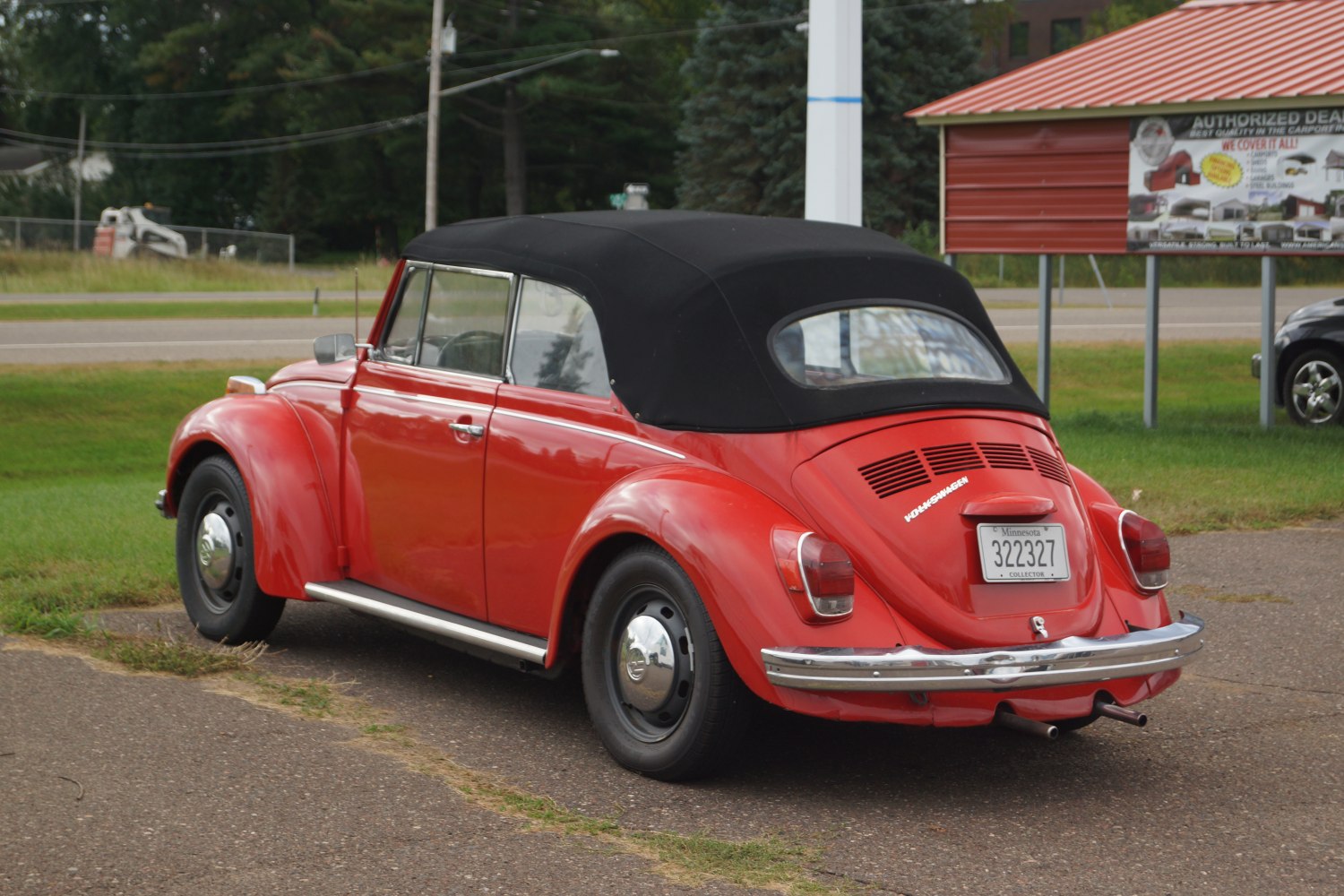 Convertible with black soft top and rounded rear fenders