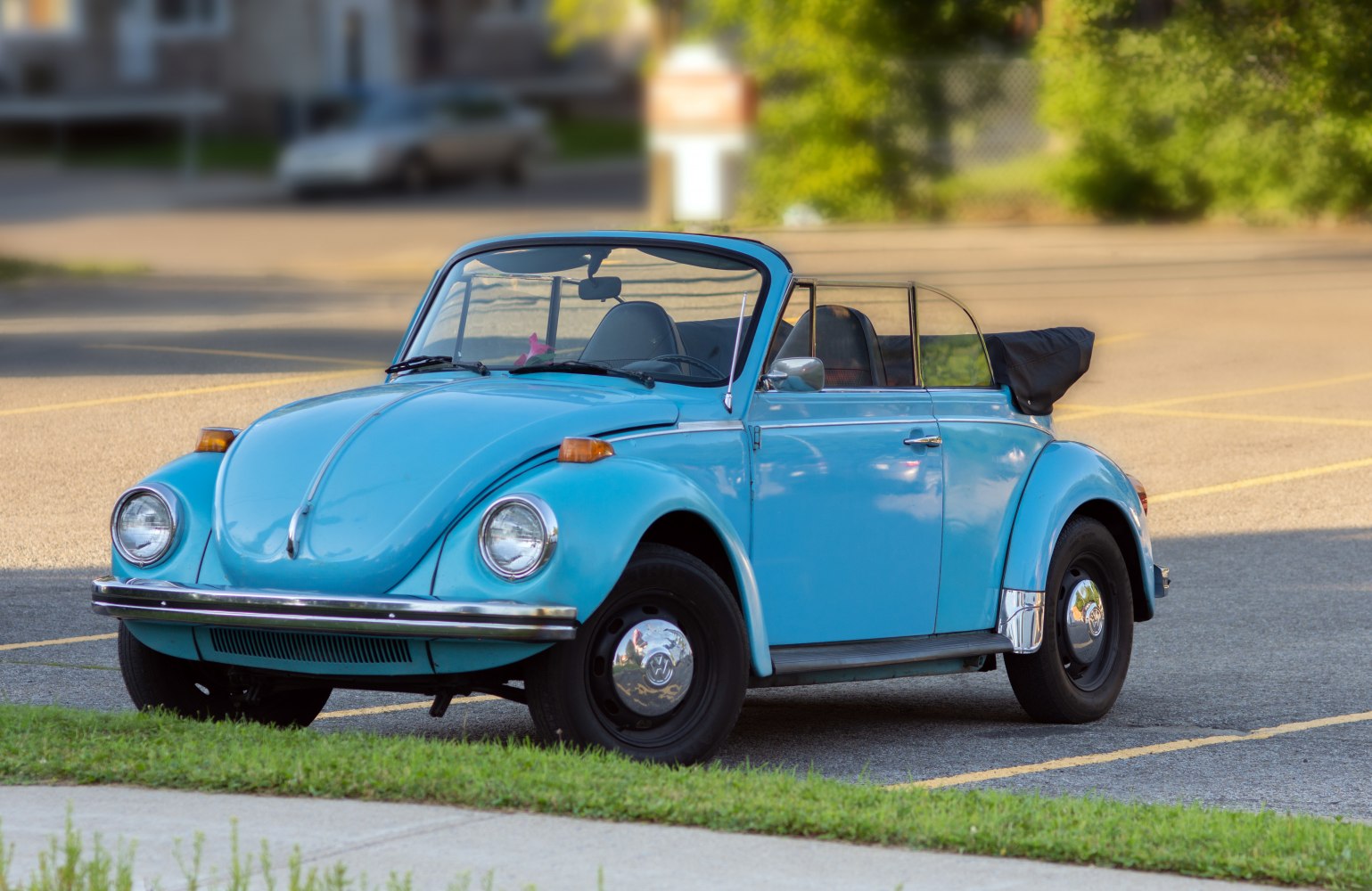 Vintage convertible car with round headlights and retro styling