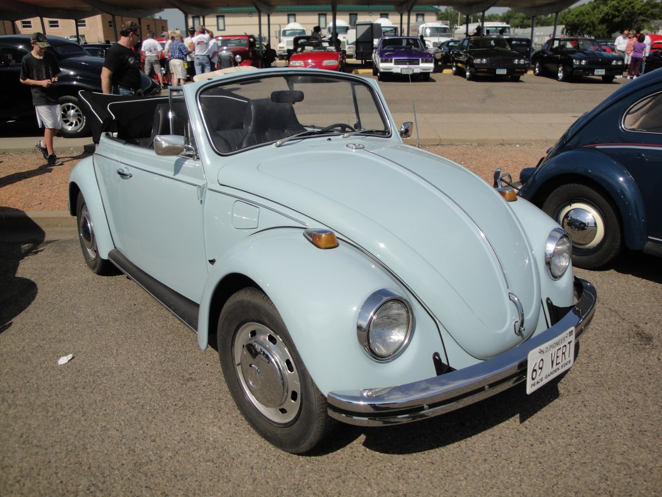Vintage convertible with round headlights and chrome bumper