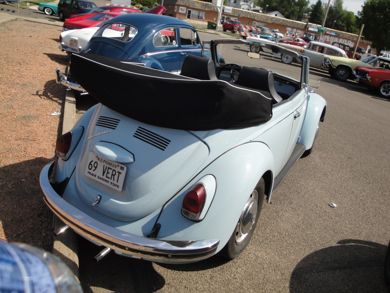 Rear view of vintage convertible with soft top and chrome bumper