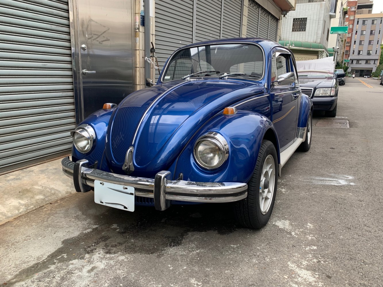 Blue vintage Beetle with rounded headlights and chrome bumpers