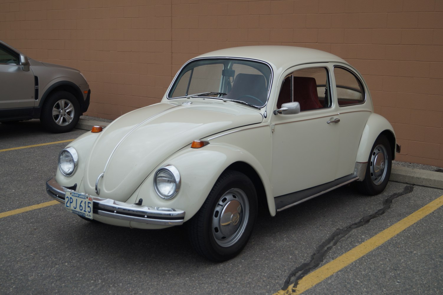 Vintage compact two-door sedan with rounded design and chrome bumpers.