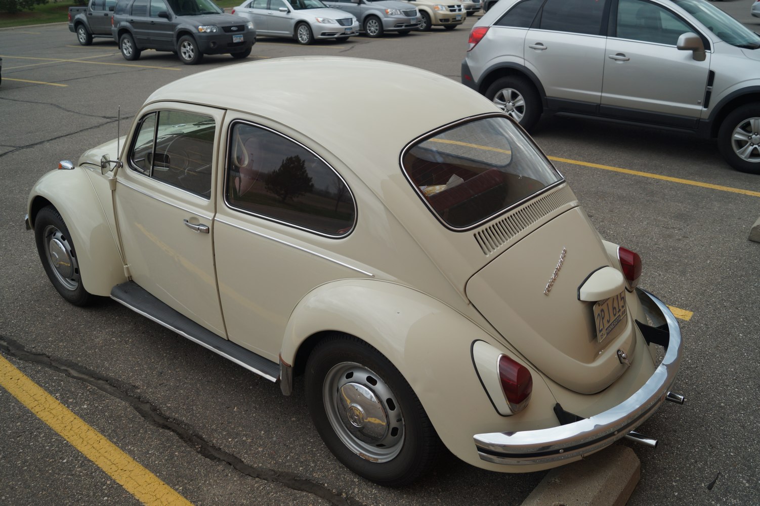 Rounded rear design with rear window ventilation slots and chrome bumper.