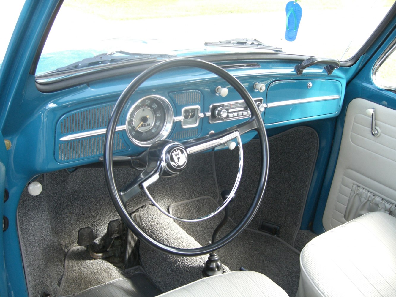 Classic vintage steering wheel with chrome accents and dashboard features.