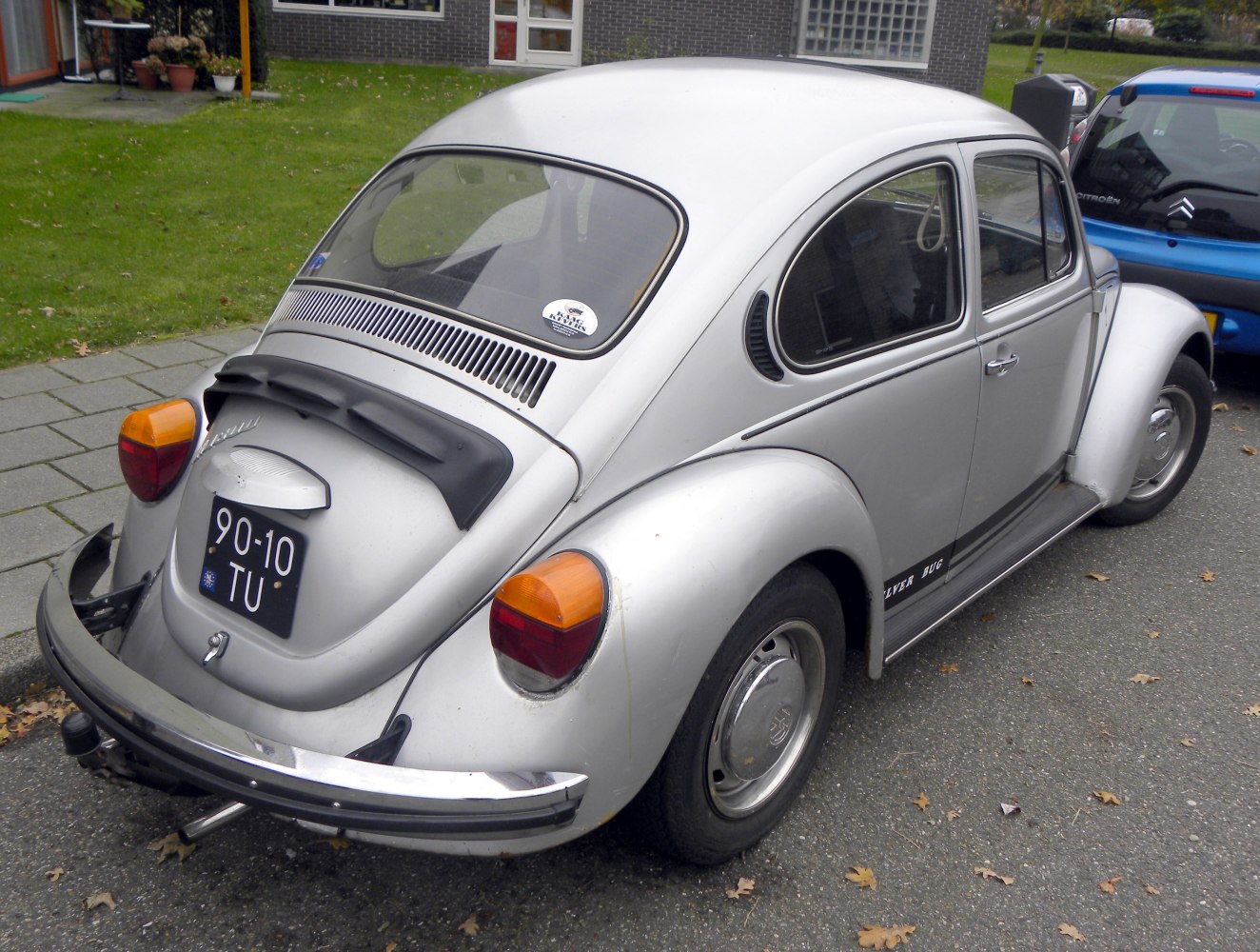 Rear view with curved body and distinct tail lights of a vintage rounded-back vehicle