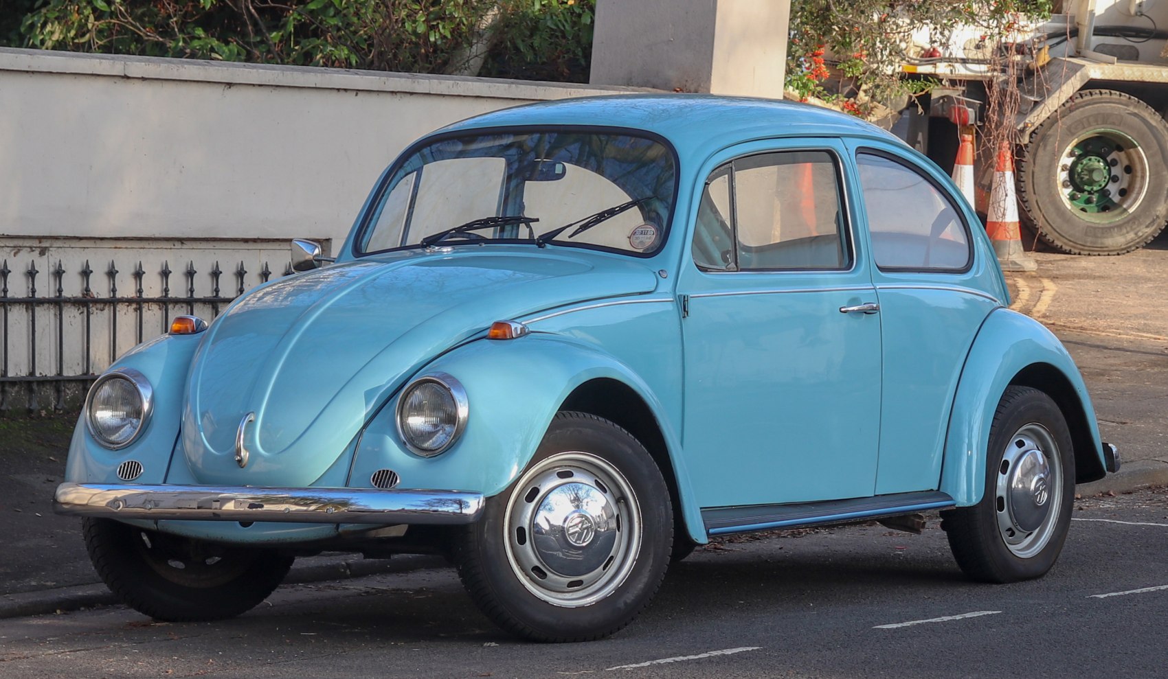 Vintage classic blue vehicle with rounded fenders and chrome bumpers