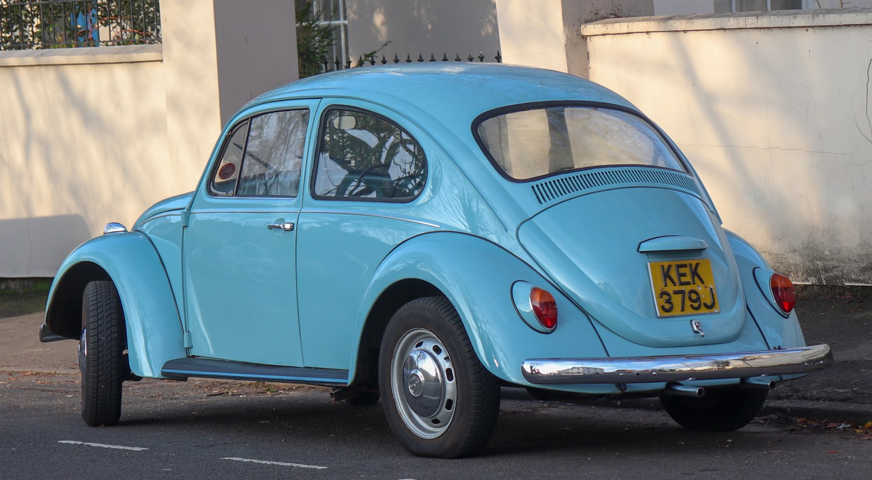 Rear view of vintage rounded classic car with chrome bumper