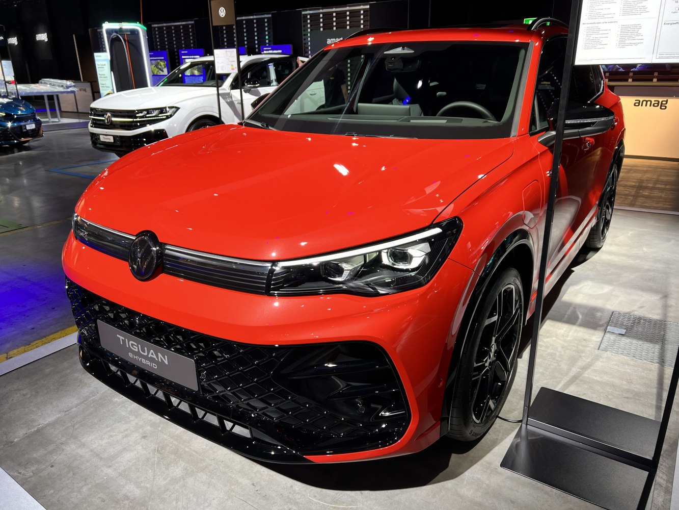 Sharp LED headlights and bold front grille of a red SUV
