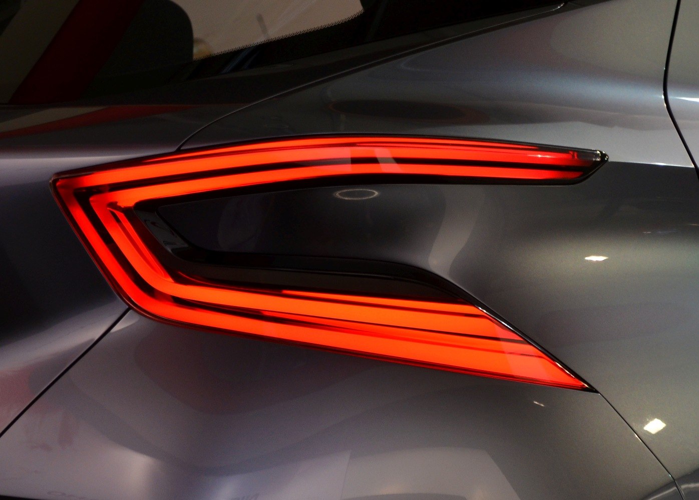 Rear LED taillight with sleek, angular shape and vibrant red illumination