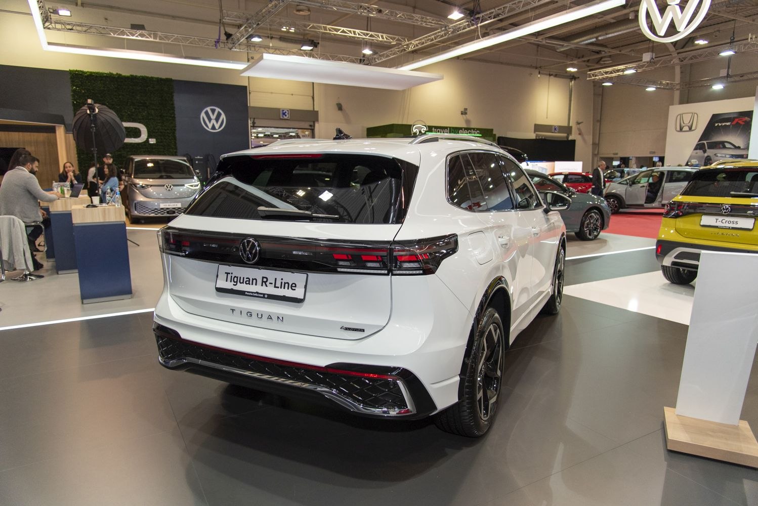 Rear view of white SUV with modern taillights and sporty bumper.