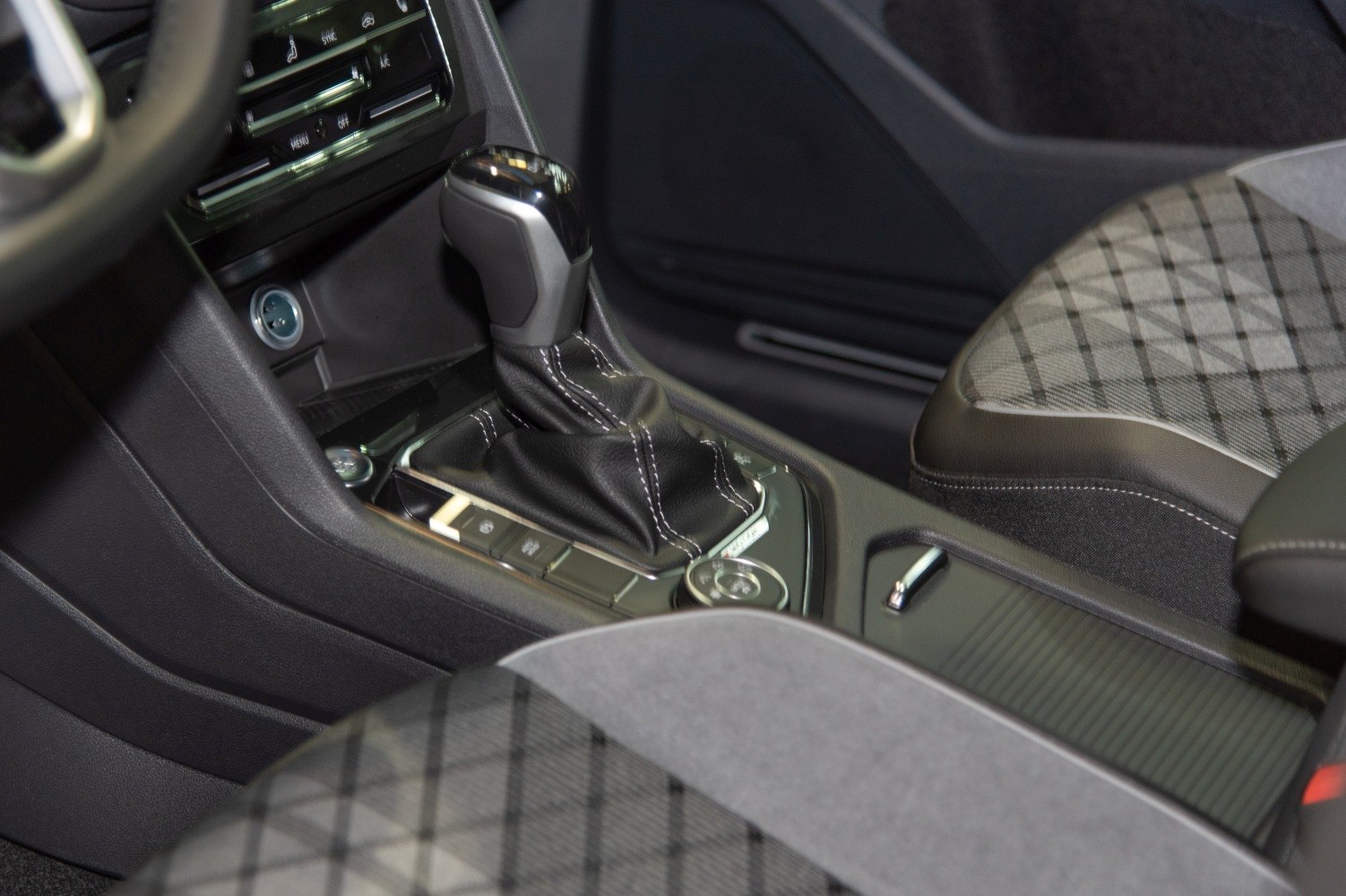 Gear shift console and patterned fabric seats inside vehicle