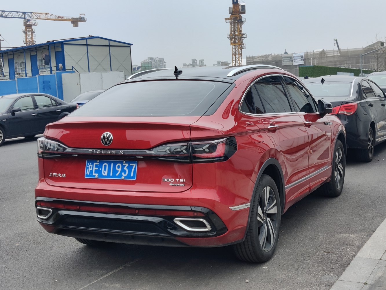 Rear view of a red SUV with sleek taillights and spoiler