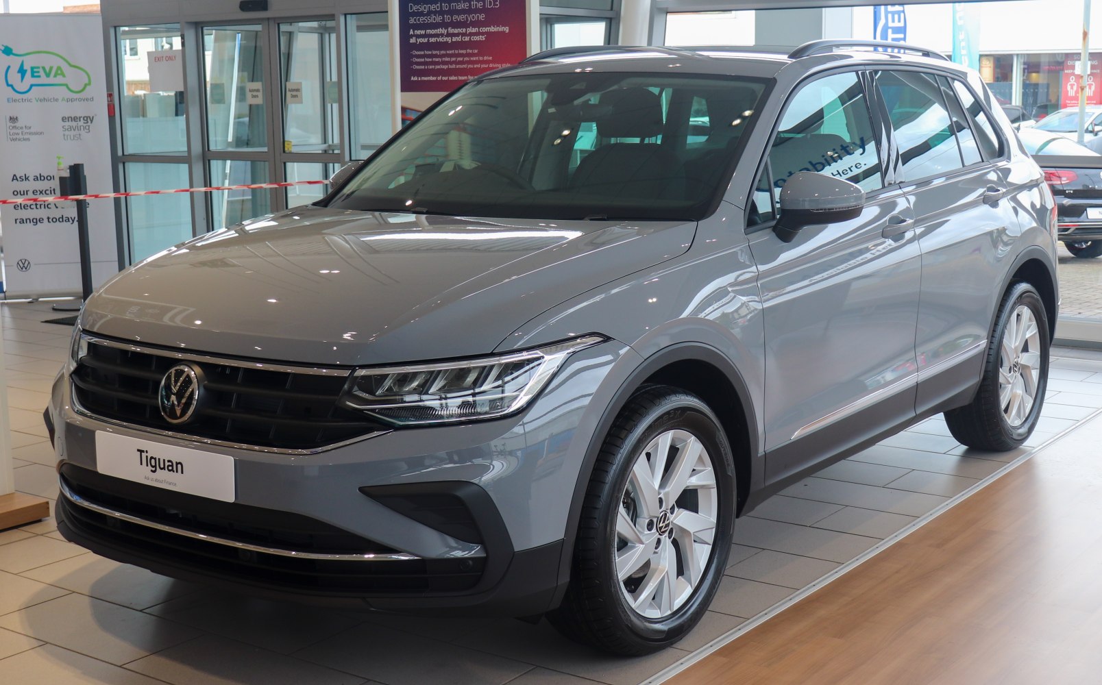 Front and side view of a grey mid-size SUV with distinctive LED headlights and alloy wheels.