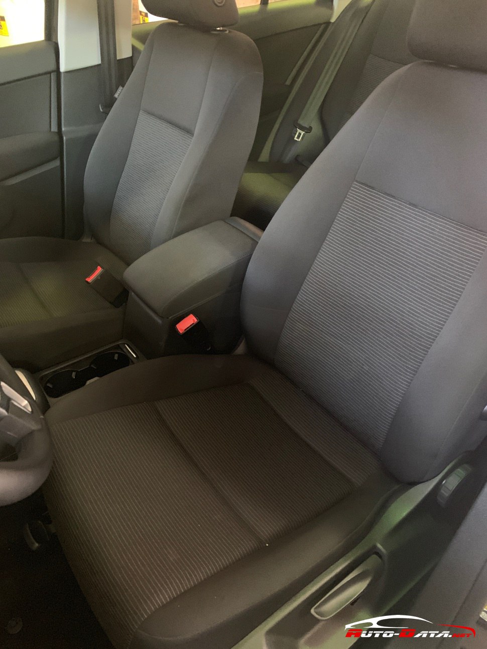 Front seats upholstery and center armrest in car interior