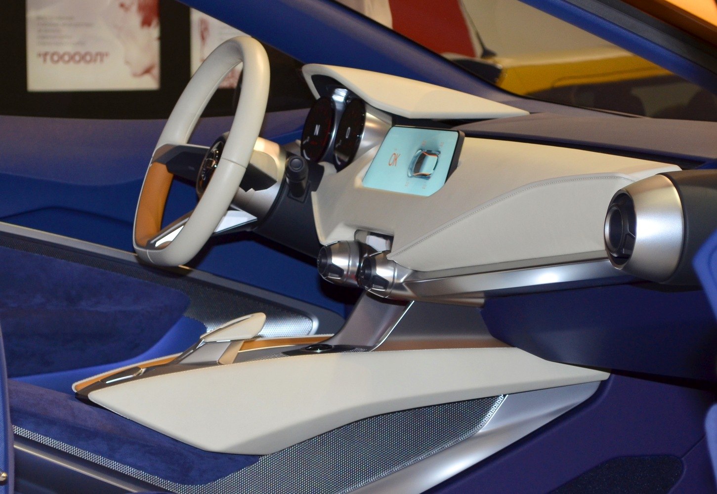 Futuristic concept car interior with sleek dashboard and unique steering wheel.