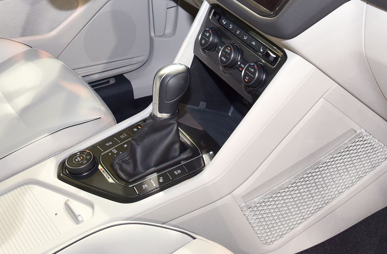Gear shift lever and climate control panel in light car interior