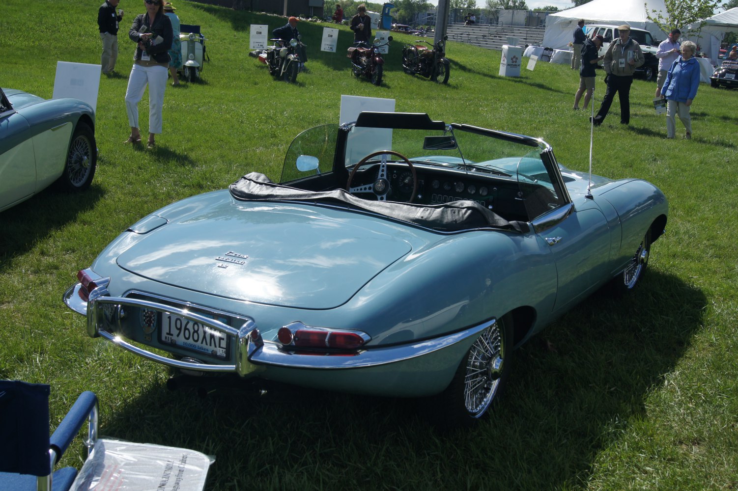 Classic convertible sports car rear with wire wheels and light blue paint