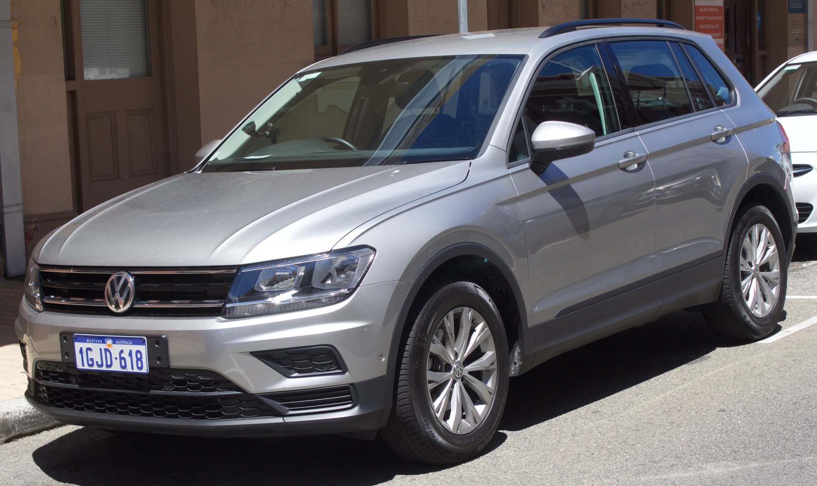Silver mid-size SUV with LED headlights and front grille