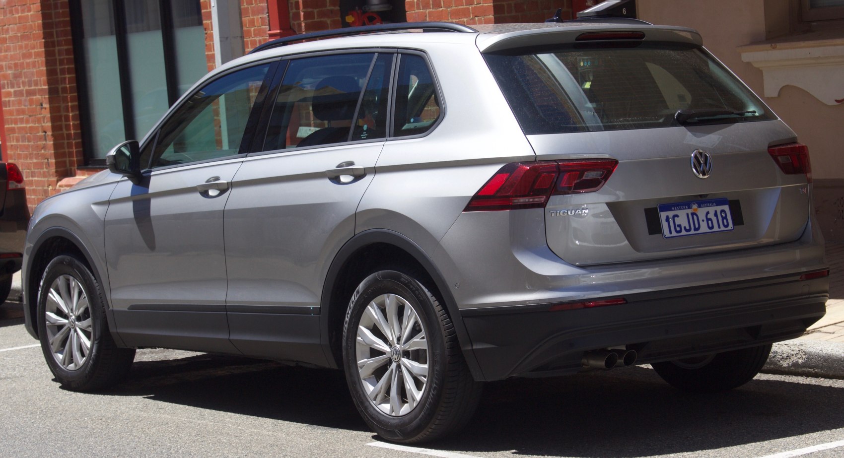 Rear side view with tail lights and alloy wheels